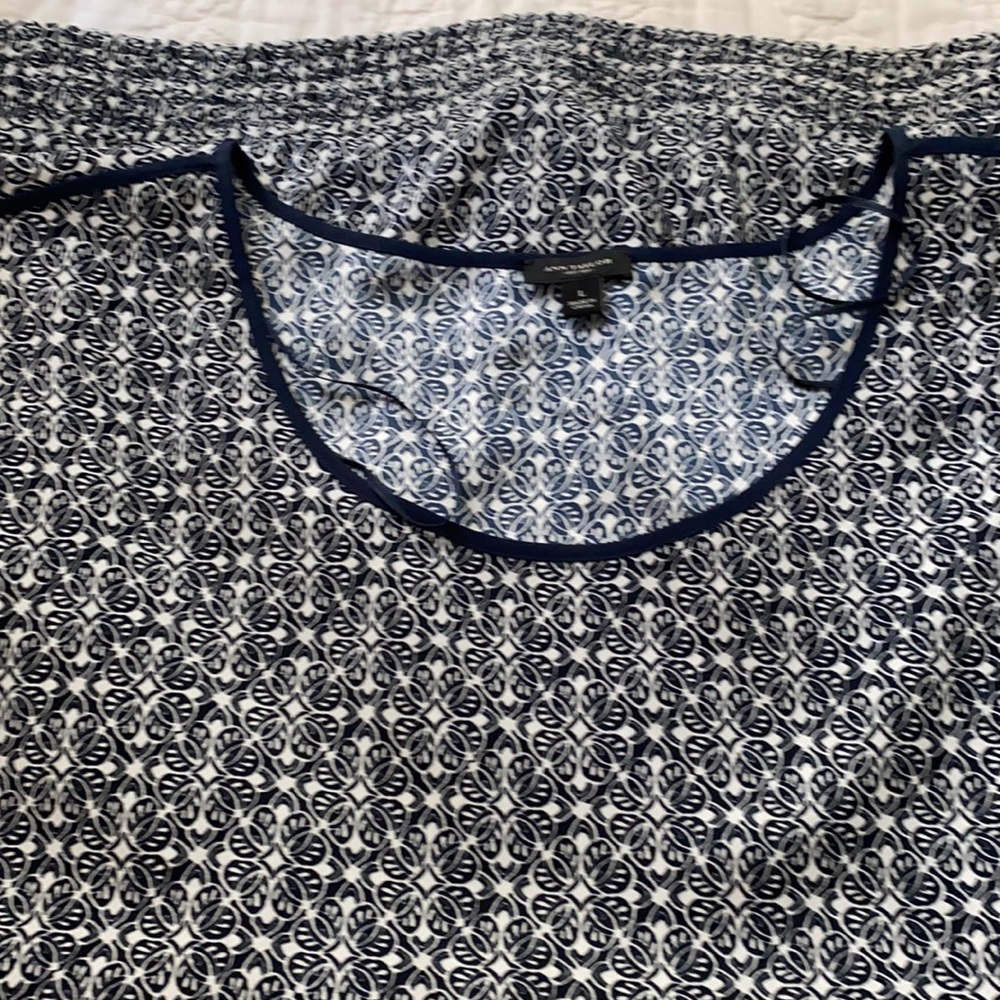 Ann Taylor navy blue and white sleeveless blouse.